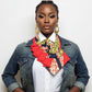 Woman wearing a colorful necktie with a denim jacket on a white background