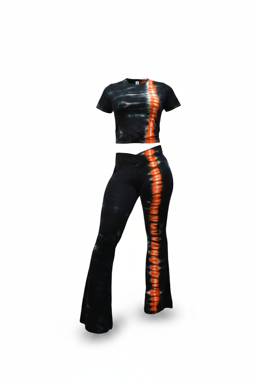 Woman wearing a black outfit with orange tie-dye patterns on a white background