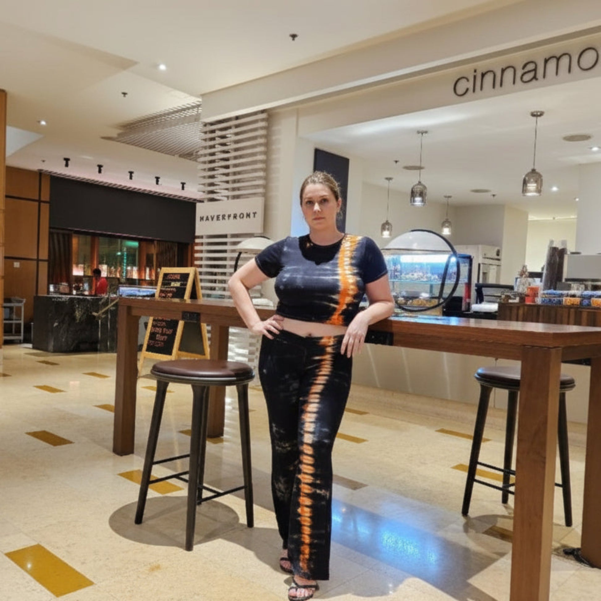 Woman wearing two piece pants set in a cafe setting