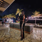 Woman wearing two piece pants set with palm trees in the backround