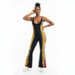 A woman modeling a sleeveless black flared jumpsuit with a vibrant yellow, orange