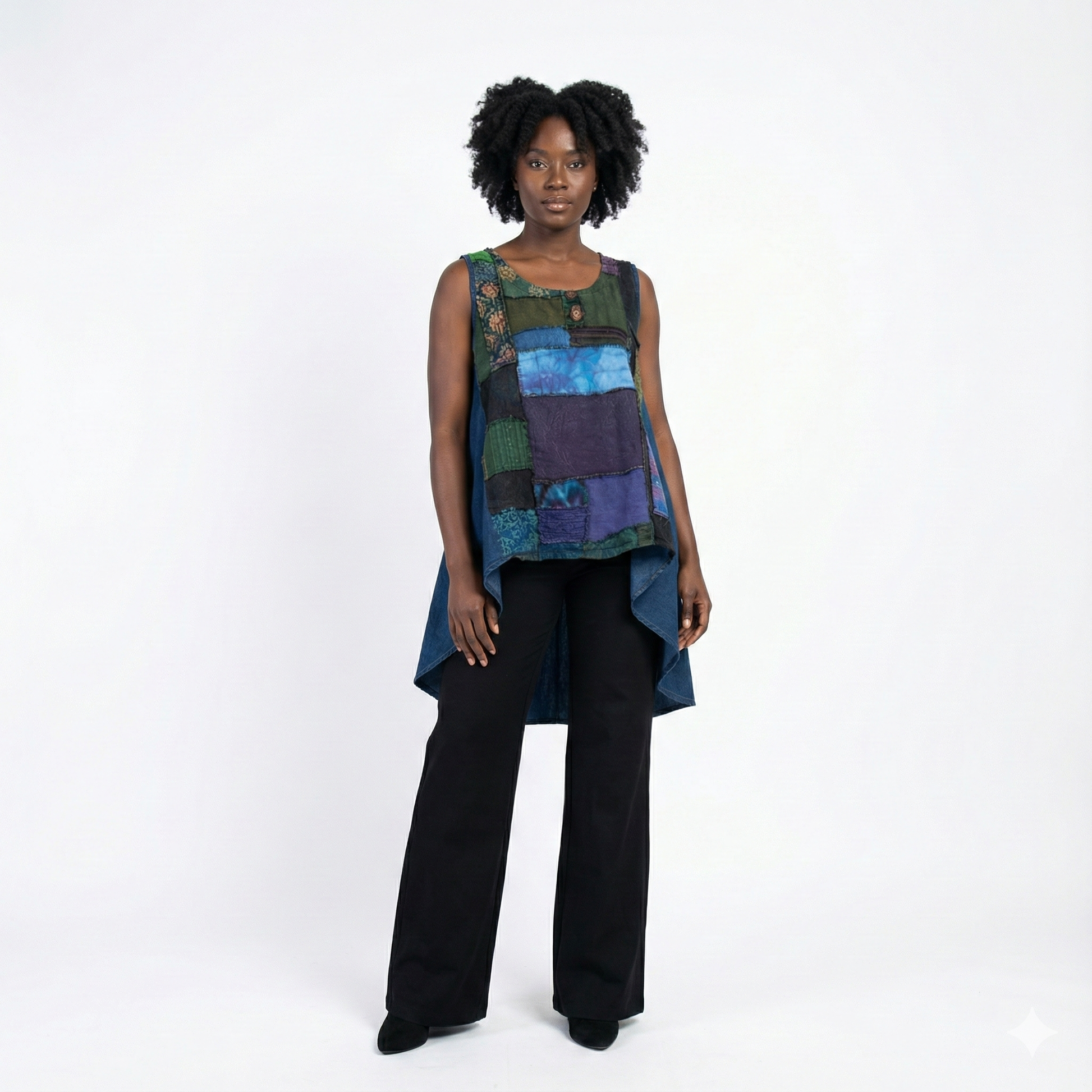 Woman wearing a colorful sleeveless top and black pants on a white background