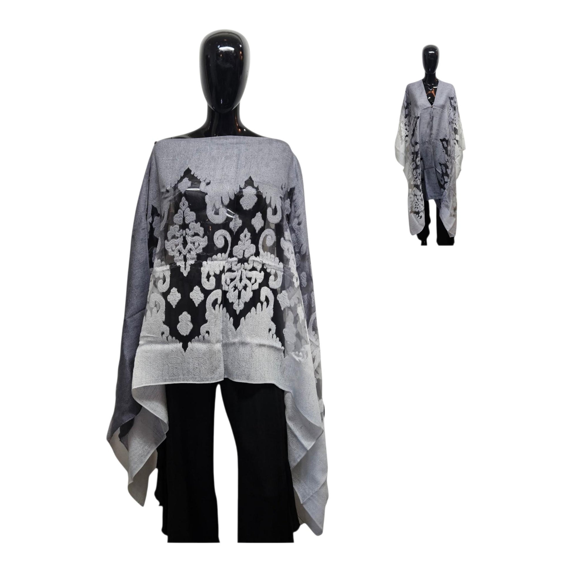 Gray and black patterned poncho on a mannequin against a white background