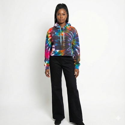Person wearing a tie-dye hoodie and black pants on a white background