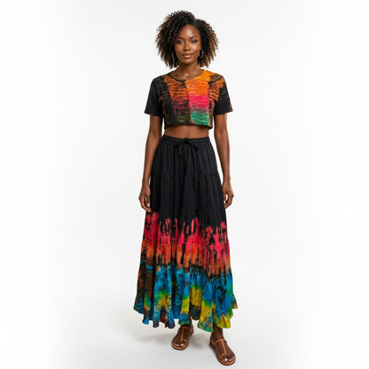 Woman wearing a colorful tie-dye top and black skirt on a white background