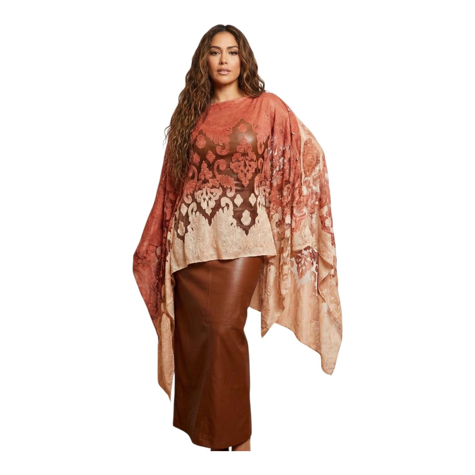 Woman wearing a patterned shawl over a plain background