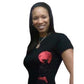 Woman smiling, wearing a black t-shirt with a red rhinestone and reflective film afro design.