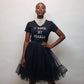 Woman wearing a black t-shirt with 'I Rock My Pearls' text and a black tulle skirt.
