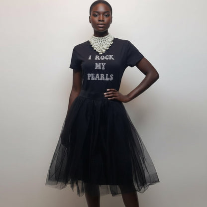 Woman wearing a black dress with 'I Rock My Pearls' text and a tulle skirt.