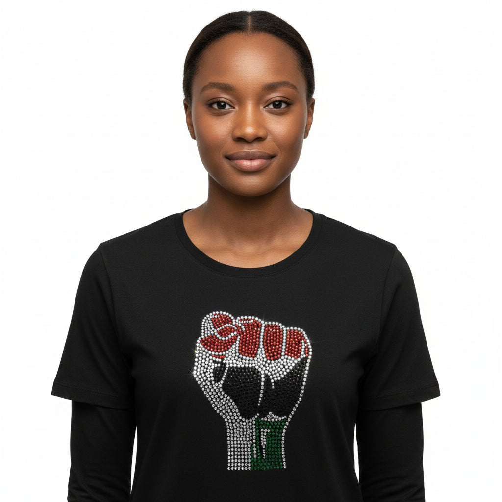 Woman wearing a black 100% cotton t-shirt with  rhinestone Black Power fist red, black, and green.