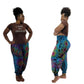 Woman wearing a brown t-shirt with text and colorful tie-dye pants on a white background